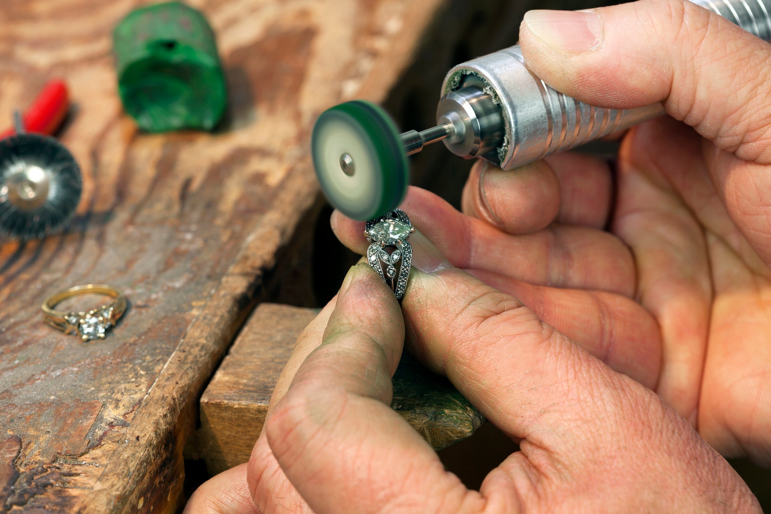 A Jeweler Polishing a Diamond Ring.