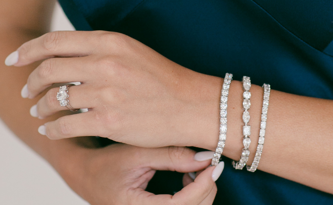 Woman adjusting a diamond bracelet on her wrist