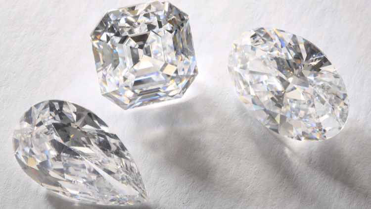 Various cuts of diamond stones refracting light from one side