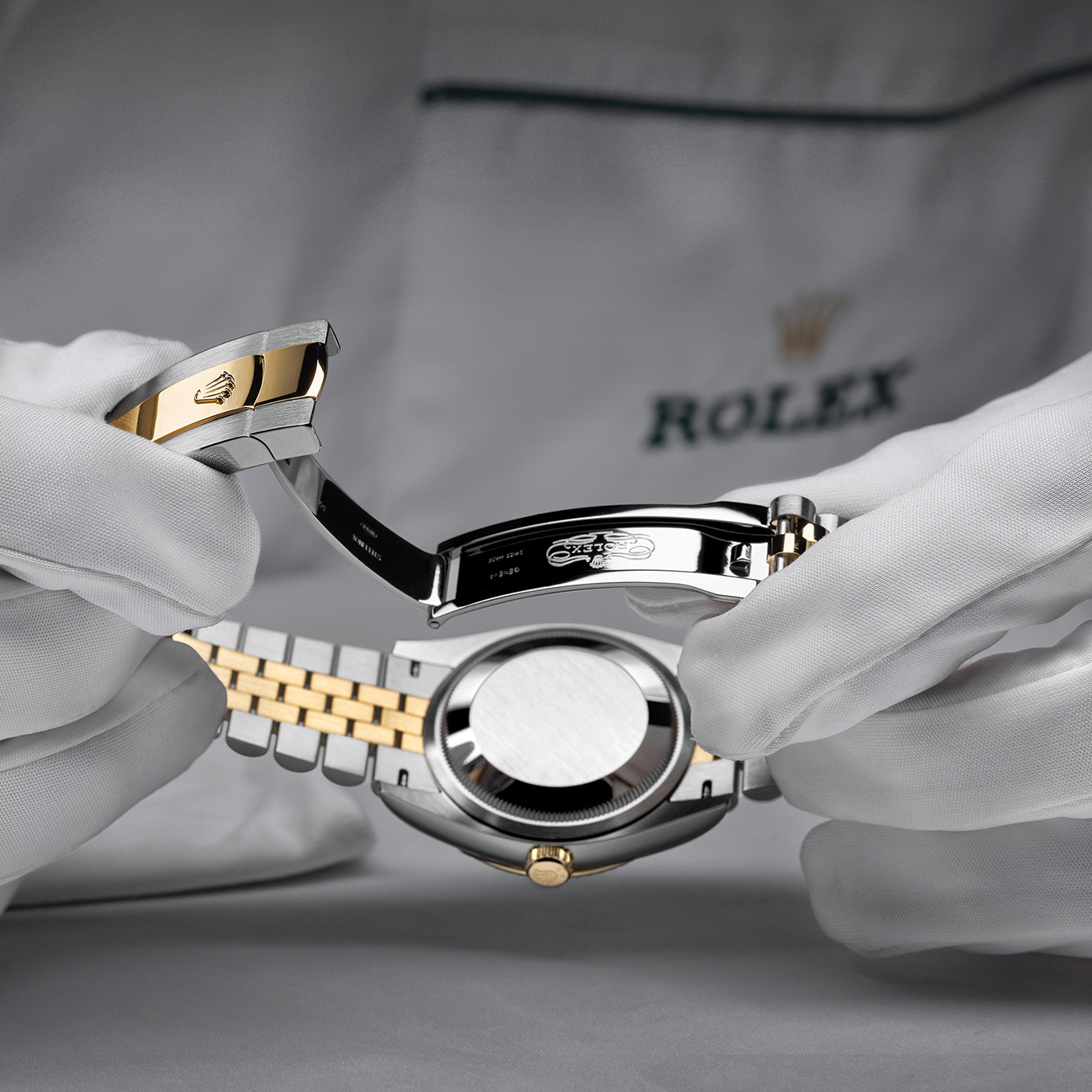 Man unclasping a rolex watch up close image