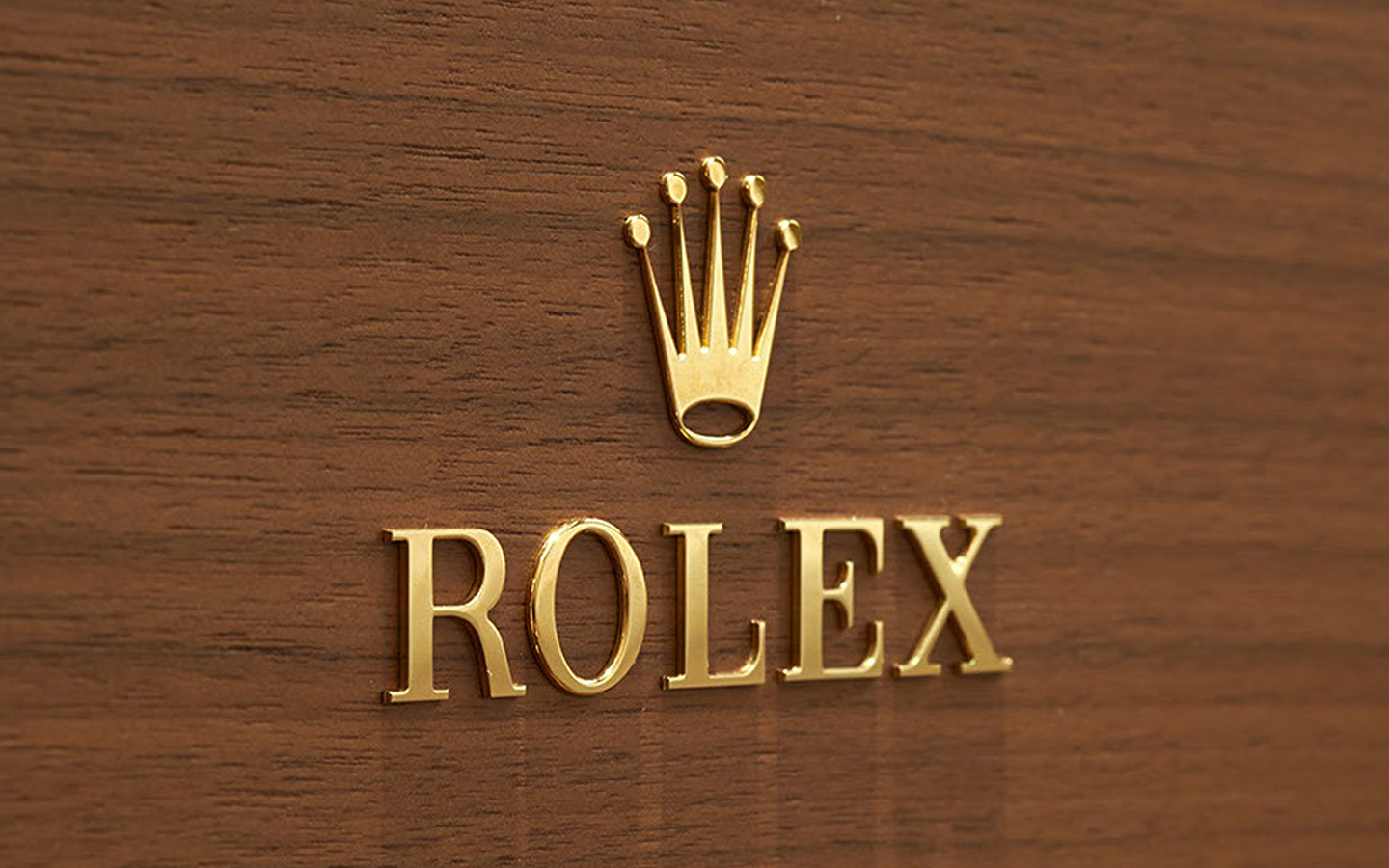 Rolex Crown Logo on Wood Wall in Raised Gold