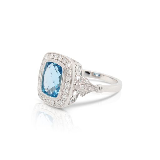 This blue topaz and diamond ring by Rafael is crafted from 14k white gold and features a 3.50 carat cushion blue topaz and 0.35 total carats of diamonds.
