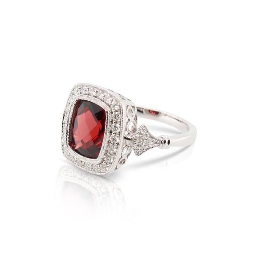 This garnet and diamond ring by Rafael is crafted from 14k white gold and features a 3.75 carat cushion garnet and 0.34 total carats of diamonds.