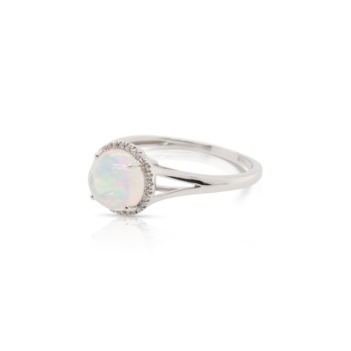 This opal and diamond ring by Rafael is crafted from 14k white gold and features a 0.95 carat opal and 0.05 total carats of diamonds around the halo.