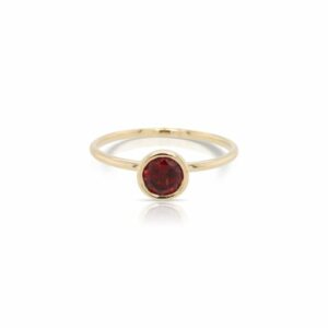 This garnet ring by Rafael is crafted from 14k yellow gold and features a 0.60 carat round garnet.