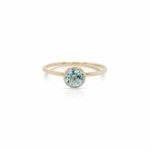 This solitaire blue topaz ring by Rafael is crafted from 14k yellow gold and features a 0.62 carat round blue topaz.