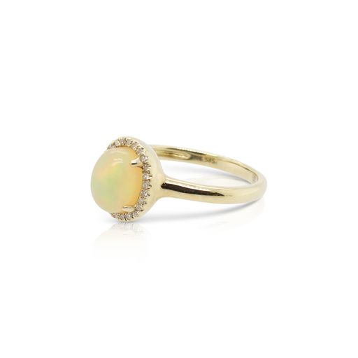 This opal and diamond ring by Rafael is crafted from 14k yellow gold and features a 0.85 carat oval opal and 0.06 total carats of diamonds around the halo.