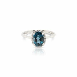 This London blue topaz and diamond ring by Rafael is crafted from 14k white gold and features a 1.50 carat oval London blue topaz and 0.06 total carats of diamonds around the halo.