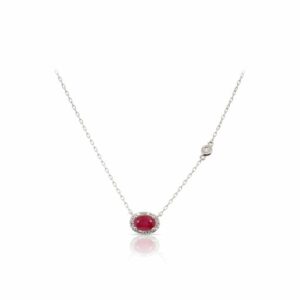 This ruby and diamond necklace by Rafael is crafted from 14k white gold and features a 0.60 carat oval ruby and 0.07 total carats of diamonds around the halo.