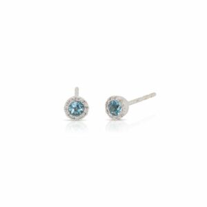 This pair of blue topaz and diamond earrings by Rafael is crafted from 14k white gold and features 0.26 total carats of round blue topaz and 0.07 total carats of diamonds around the halo.