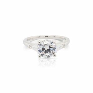 This diamond engagement ring mounting is crafted from 14k white gold and features 0.34 total carats of tapered baguette side diamonds. The center diamond is chosen separately.
