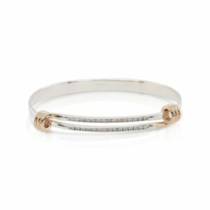 This diamond Signature bracelet by Ed Levin is crafted from sterling silver and features 14k yellow gold plated details.