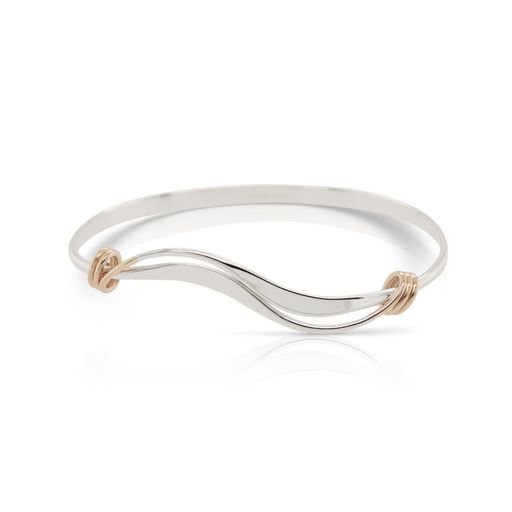 This wrap wave bracelet by Ed Levin is crafted from sterling silver and features 14k yellow gold wrap details.