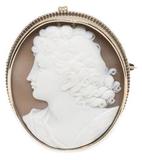 While portrait of a female on a bronze pendant.