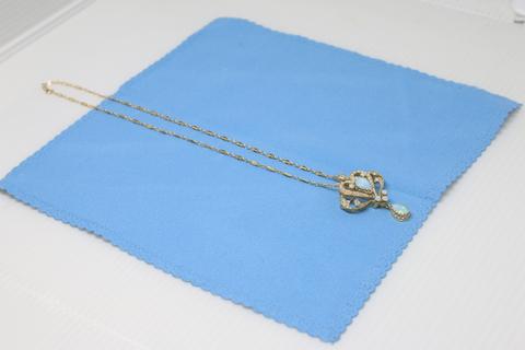Necklace on blue cloth.