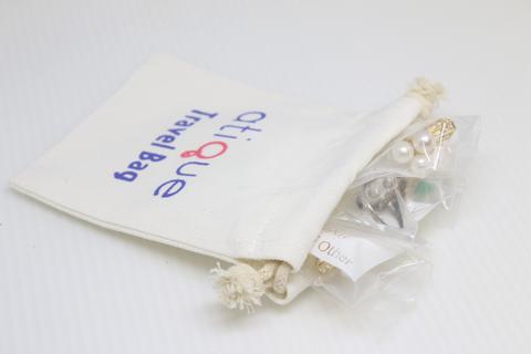 a travel bag with earrings in plastic bags.