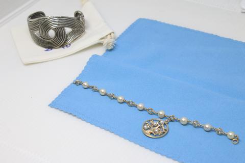 Jewelry laid on cloths on a table.