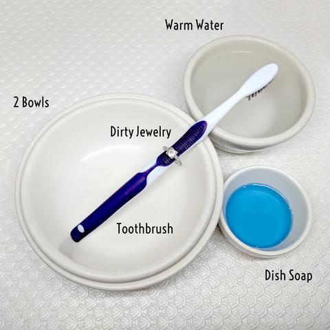 A diagram with two bowls warm water a toothbrush and dishsoap.