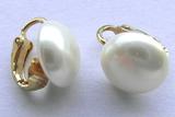 Large pearl and gold earrings.
