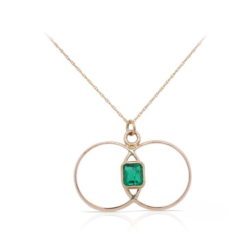 This double circle emerald necklace is crafted from 14k yellow gold and features a cushion cut emerald.