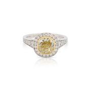 This yellow diamond ring by Forevermark is crafted from 18k white and yellow gold and features a 2.05 carat fancy light yellow diamond and 0.79 total carats of diamonds along the sides and halo.