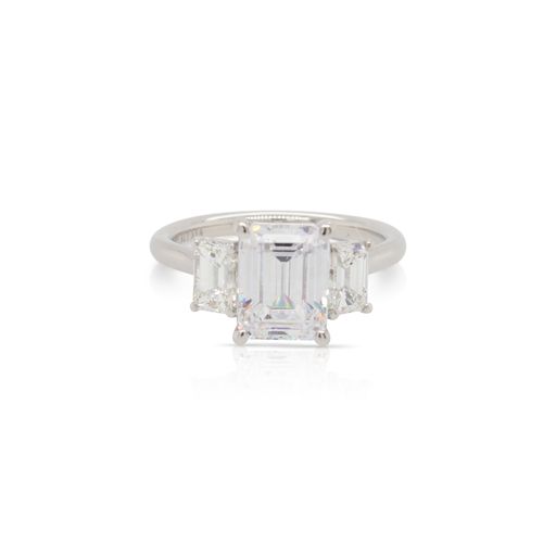 This diamond engagement ring mounting by Alyssa is crafted from platinum and features 0.80 total carats of emerald cut side diamonds. The center diamond is chosen separately.