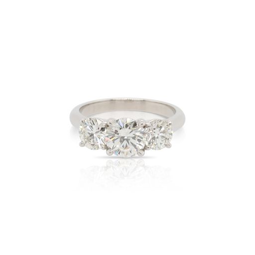 This 3 stone diamond engagement ring is crafted from platinum and features a 1.22 carat center diamond and 1.17 total carats of side diamonds.
