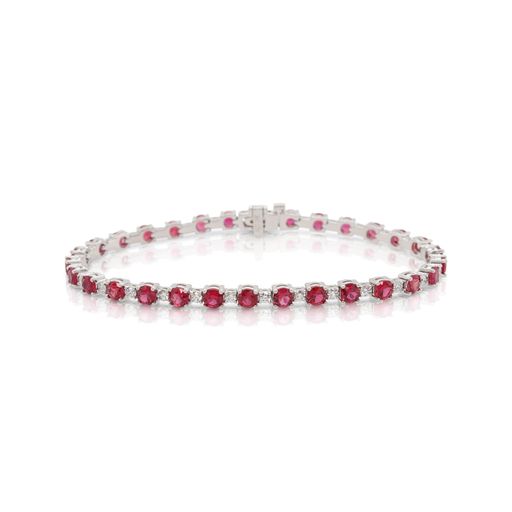 This tennis bracelet is crafted from 18k white gold and features 6.60 total carats of rubies and 1.11 total carats of diamonds.