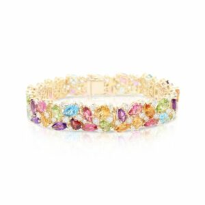 This bracelet by Norman Covan is crafted from 18k yellow gold and features multi colored gemstones and 4.21 total carats of diamonds.