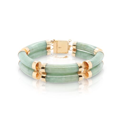 This bracelet is crafted from 14k yellow gold and features jadeite jade.This bracelet is crafted from 14k yellow gold and features jadeite jade.