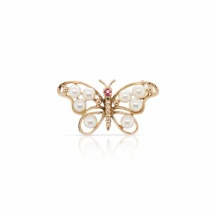 This butterfly brooch is crafted from 14k yellow gold and features white pearls on the wings.
