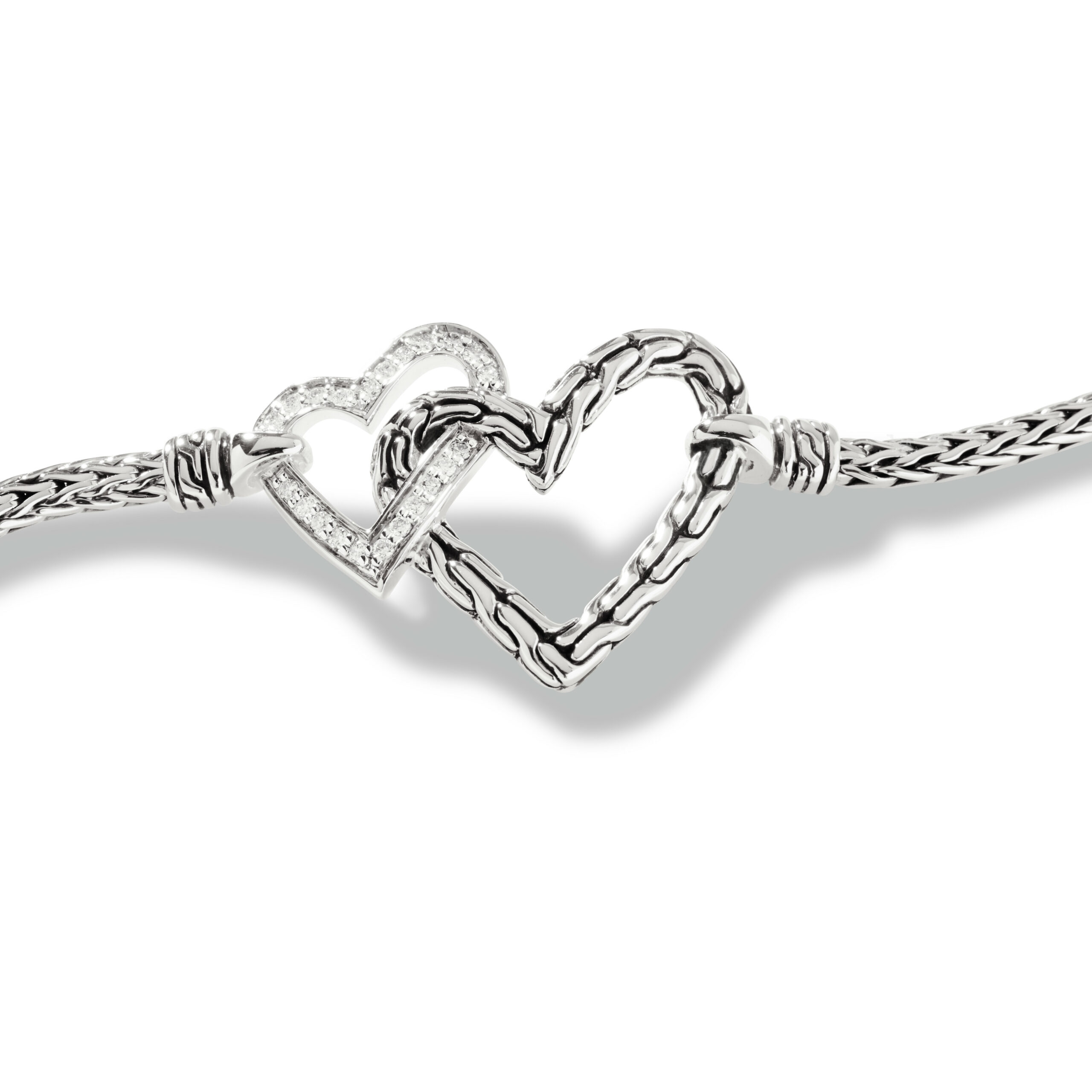 This bracelet by John Hardy is crafted from sterling silver and features 0.11 total carats of diamonds in the smaller heart.