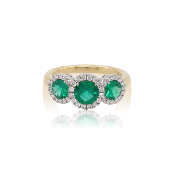This three stone ring by Spark Creations is crafted from 18k white and yellow gold and features 1.04 total carats of round emeralds and 0.97 total carats of diamonds around the halos.