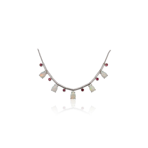 This necklace by R.F. Moeller Designs is crafted from 14k white gold and features white pear shaped opals and round rubies.