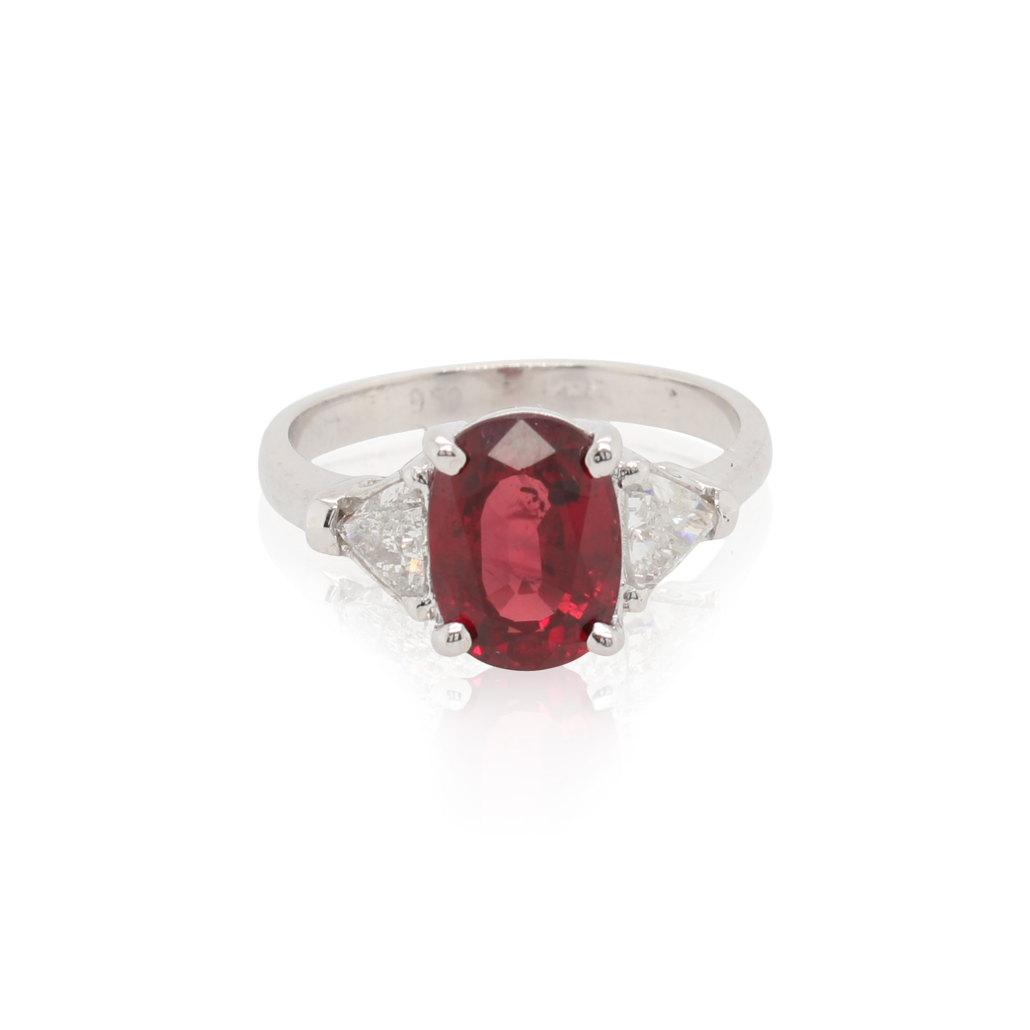 This ring is crafted from platinum and features a 3.17 carat oval ruby and 0.54 total carats of trillion side diamonds.