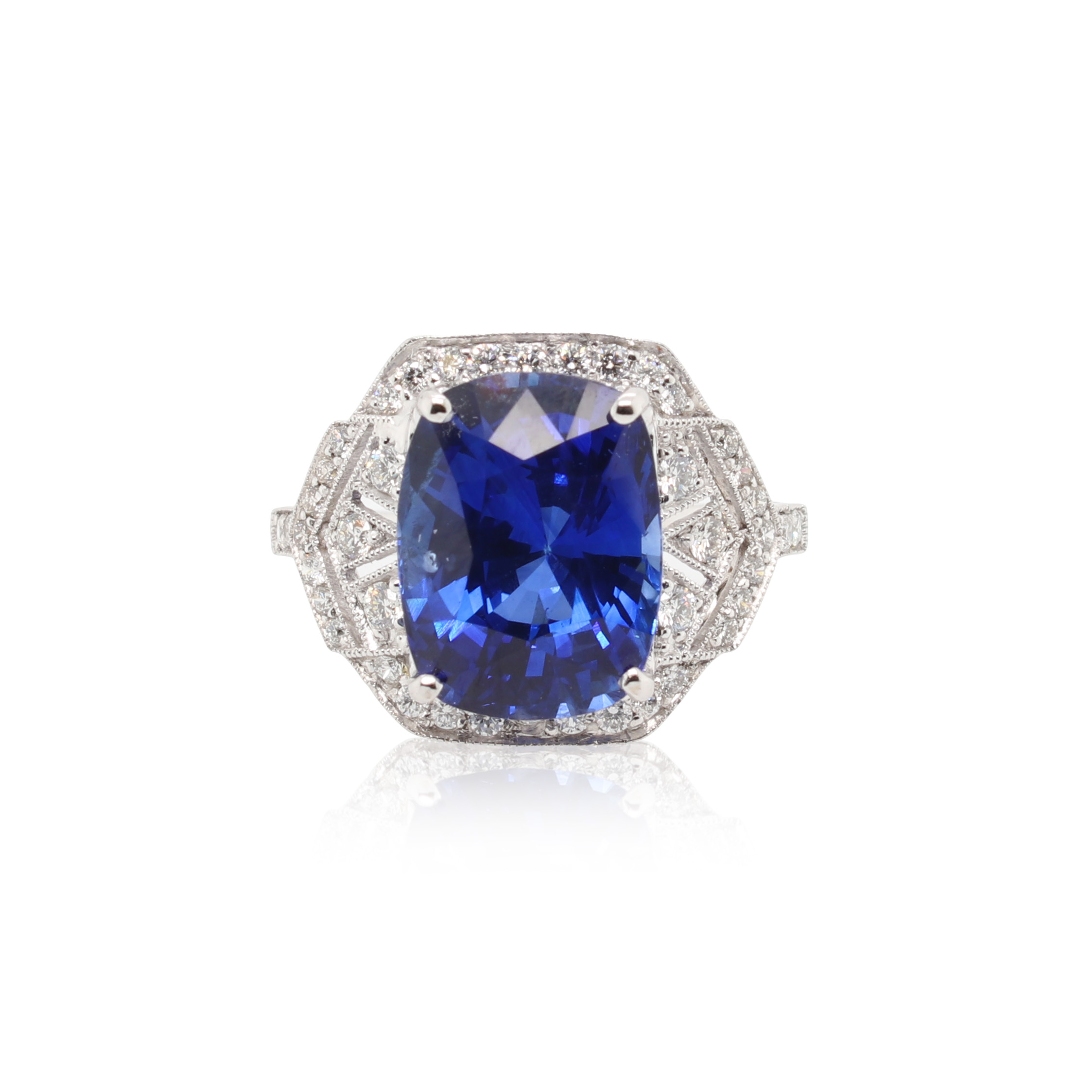 This ring is crafted from platinum and features a 7.19 carat sapphire and 0.98 total carats of diamonds along the sides and around the halo.