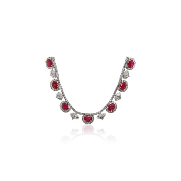 This necklace is crafted from 18k white gold and features 36.51 total carats of oval rubies and 33.24 total carats of diamonds.