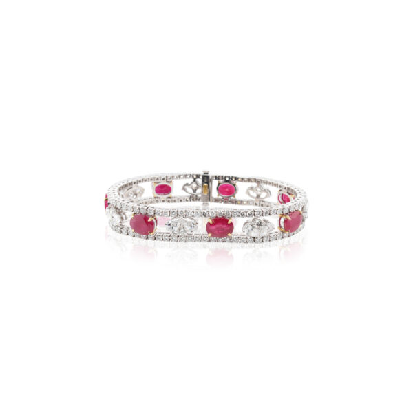 This bracelet is crafted from 18k white gold and features 13.87 total carats of oval rubies and 11.57 total carats of diamonds.