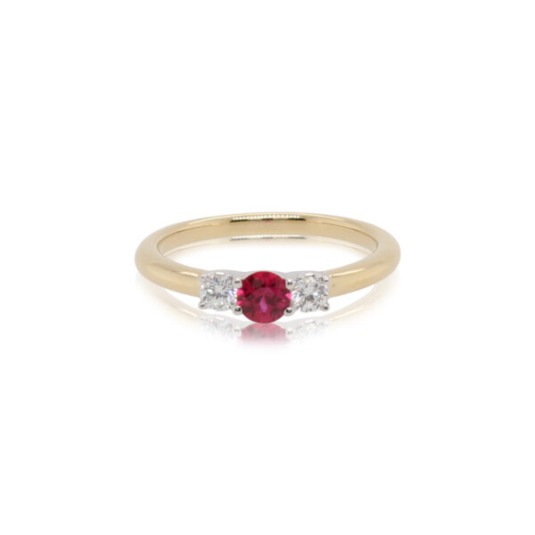 This ring by Spark Creations is crafted from 18k white and yellow gold and features a 0.30 carat round ruby and 0.18 total carats of side diamonds.