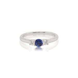 This ring by Spark Creations is crafted from 18k white gold and features a 0.30 carat round sapphire and 0.18 total carats of side diamonds.