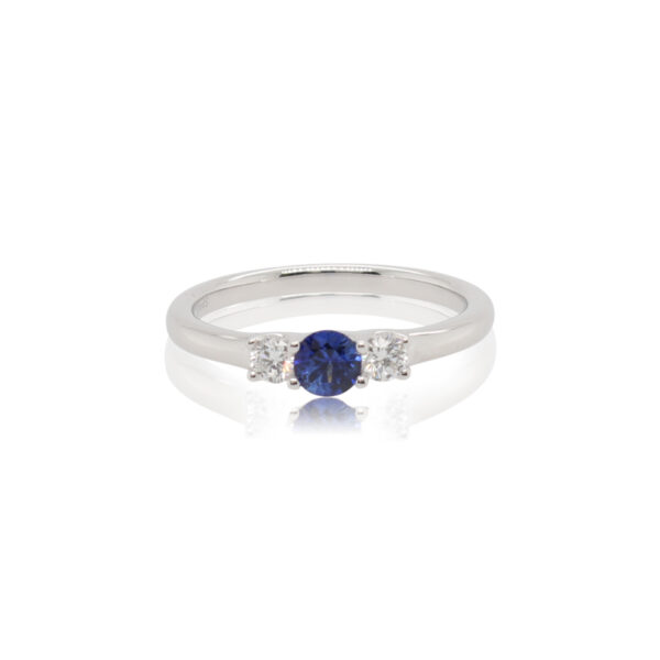 This ring by Spark Creations is crafted from 18k white gold and features a 0.30 carat round sapphire and 0.18 total carats of side diamonds.