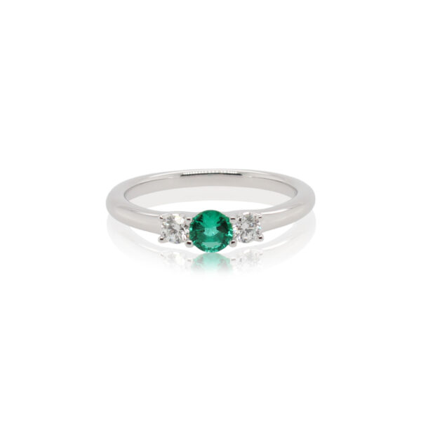 This ring by Spark Creations is crafted from 18k white gold and features a 0.25 carat round emerald and 0.18 total carats of side diamonds.