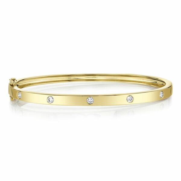 This bangle bracelet is crafted from 14k yellow gold and features 0.38 total carats of diamonds.