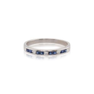 This ring is crafted from 14k white gold and features 0.18 total carats of channel set sapphires and 0.05 total carats of channel set diamonds.