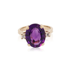 This ring is crafted from 14k yellow gold and features a large oval amethyst and 0.04 total carats of diamonds.
