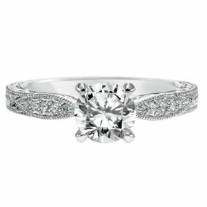 This engagement ring mounting by Goldman is crafted from 14k white gold and features 0.12 total carats of diamonds along the sides. The center diamond is chosen separately.