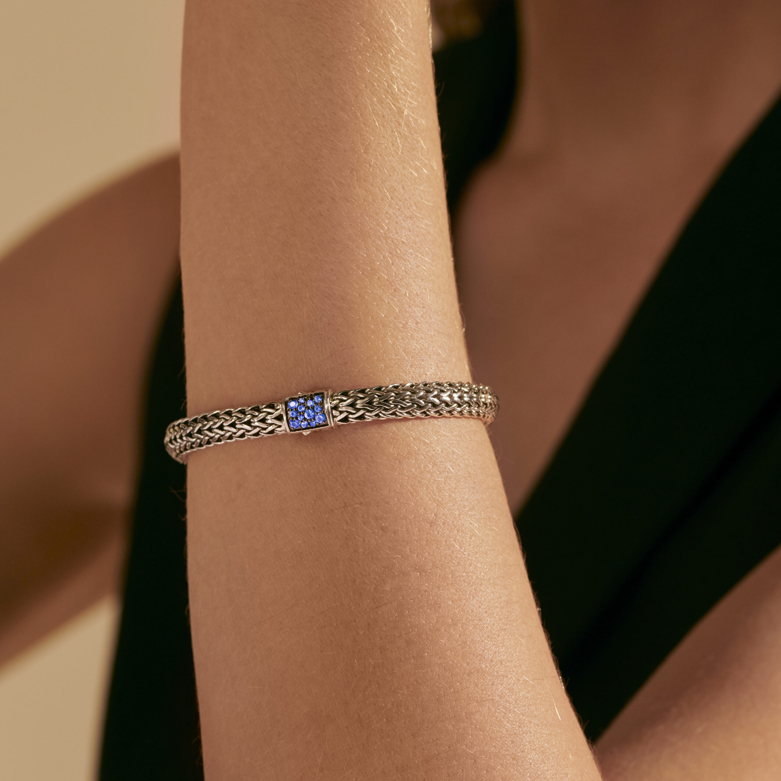 This bracelet by John Hardy is crafted from sterling silver and features black and blue sapphires in the clasp.